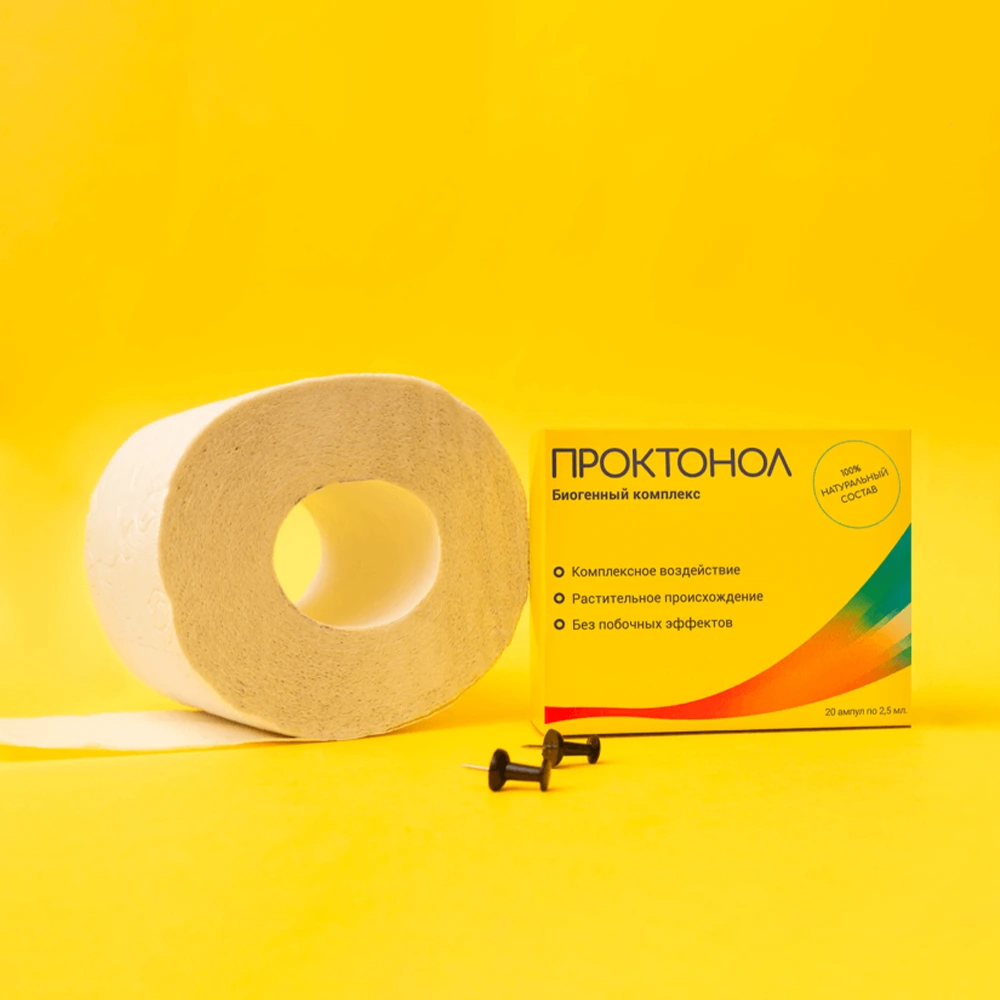 Туалетная бумага и две канцелярские булавки лежат рядом с упаковкой Проктонола